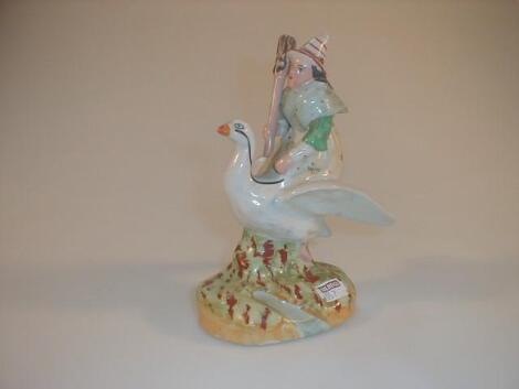 A Staffordshire type pottery figure of a witch riding on the back of a goose