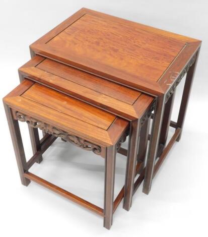 A nest of three oriental hardwood tables