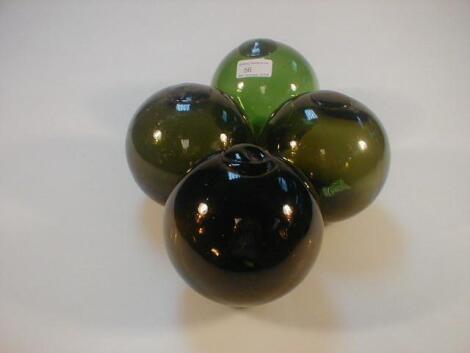 Four green glass floats