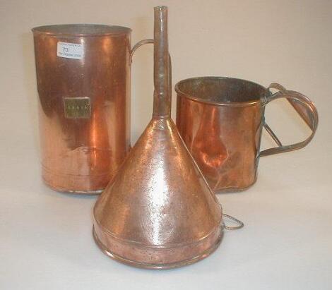 A copper ale funnel, two copper grain measures