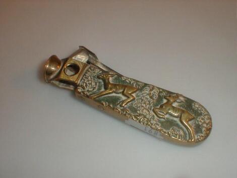 A heavy cast brass cigar cutter with stags in relief