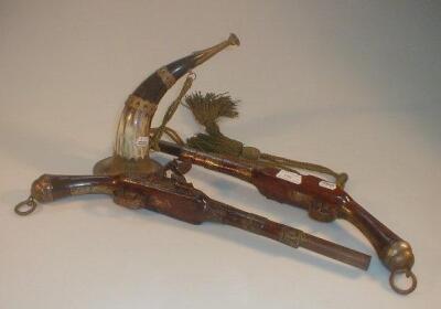 A pair of decorative Flintlock pistols and a horn trumpet