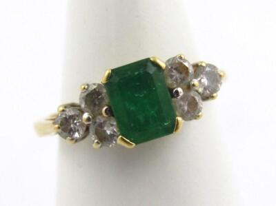 An 18ct gold emerald and diamond dress ring