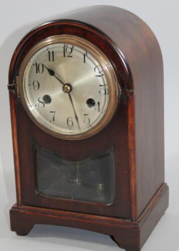 An early 20thC stained oak cased domed top mantel clock