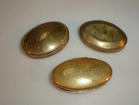 A Victorian oval brass miners snuff box and two other similar snuff boxes