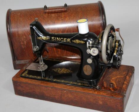 An early 20thC oak cased Singer sewing machine