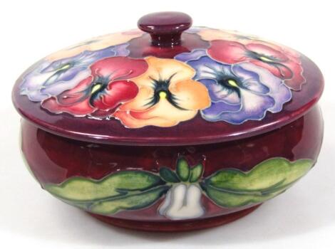 A modern Moorcroft Pansy pattern jar and cover