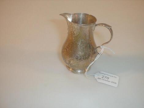 A George V silver cream jug by Goldsmiths and Silversmiths Co. Ltd