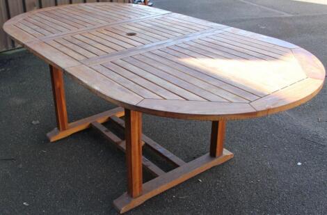 A slatted teak style extending patio table