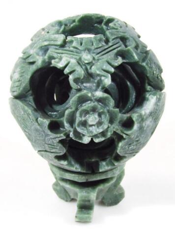 A polished stone jade coloured puzzle ball