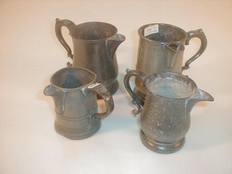 A Victorian quart pewter measure with pouring spout and double #C' scroll