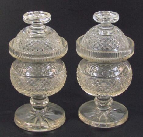 A pair of early 19thC cut glass jars and covers