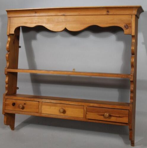 An early 20thC stripped and lightly polished pine hanging shelf