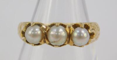 An Edwardian pearl three stone ring