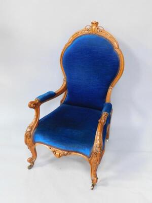 A Victorian oak spoon back lady's armchair