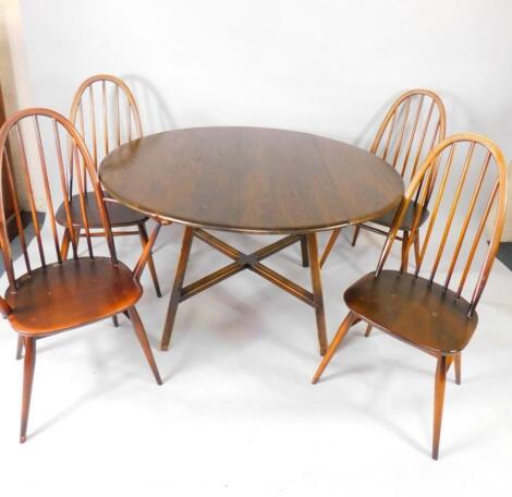 An Ercol circular oak dropleaf dining table