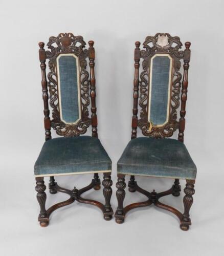 A pair of Victorian Carolean style oak high back hall chairs