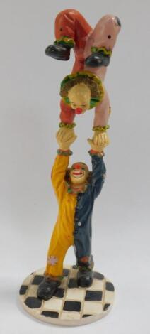 An Italian retro plaster sculpture modelled as a pair of acrobatic clowns