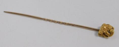 A gold nugget stick pin