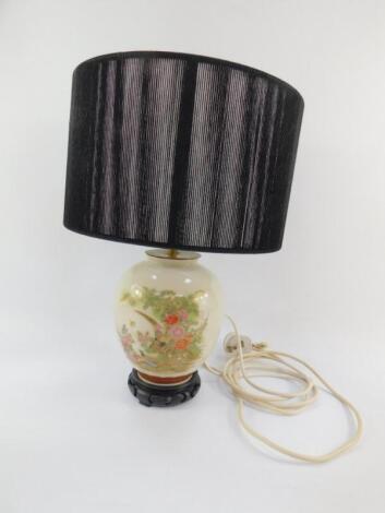 A Japanese pottery table lamp decorated with pheasants and peonies