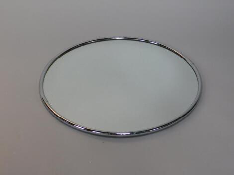 A circular chrome framed shop wall mirror