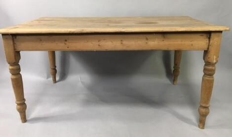 A stripped pine planked top kitchen table