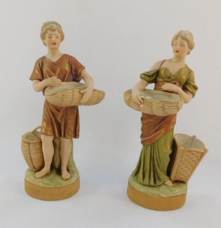 A pair of Royal Dux porcelain figures of a Roman man and lady