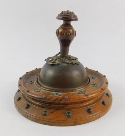 A Victorian Gothic copper and rosewood table bell on stand.