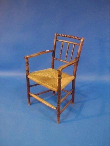 An early 19thC ash and elm gate back carver chair