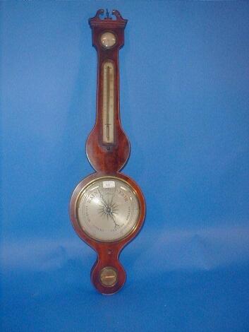 An early 19thC flamed mahogany wheel barometer with swan neck pediment