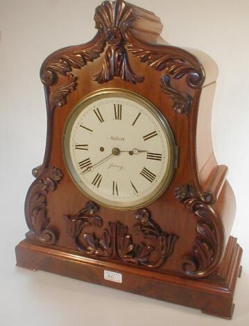 A Victorian flamed mahogany bracket clock of carved and shaped form case