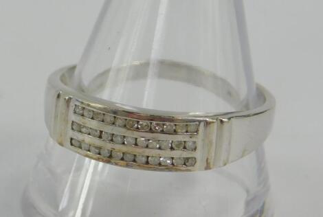 A 9ct white gold and diamond three row half eternity band