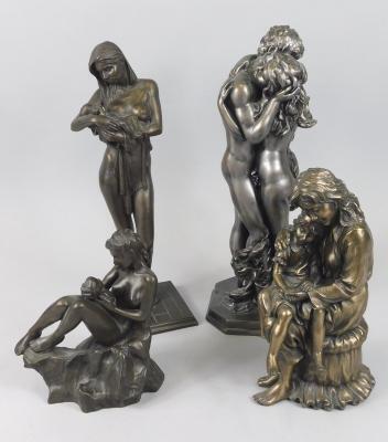 Two similar silvered resin figures