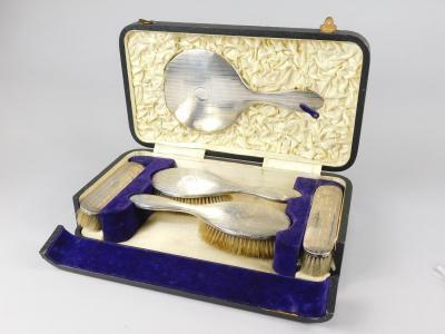 A George V silver travelling dressing table set