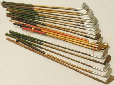 A collection of hickory shafted and metal shafted golf clubs