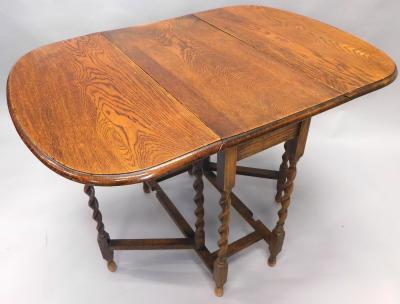 An early 20thC oak dropleaf barleytwist table