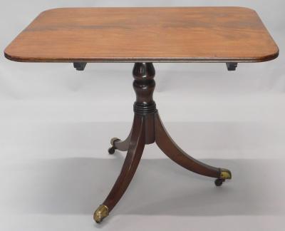 An early 19thC flame mahogany tilt top table