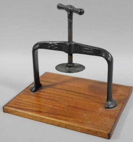 A 20thC cast iron and wooden press