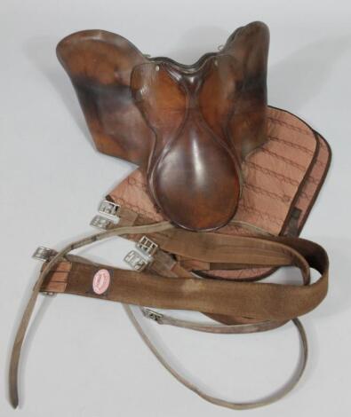 A brown leather riding saddle