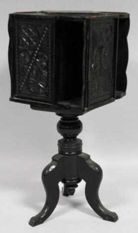 A late 19thC ebonised rotating book cabinet