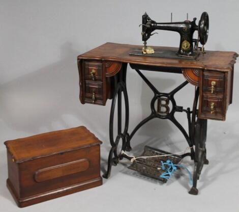 An early 20thC treadle sewing machine cabinet