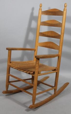 A 20thC stripped light wood rocking chair