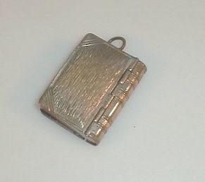 An early 20thC silver plated vesta and stamp case combined in the form of a book