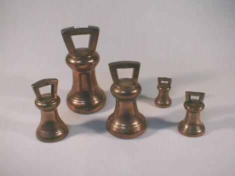 A graduated set of bronze bell weights stamped Market Deeping and graduating with 2