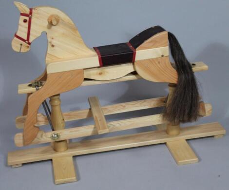 A modern stripped pine rocking horse