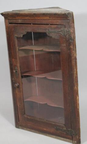 A rustic oak hanging corner cupboard