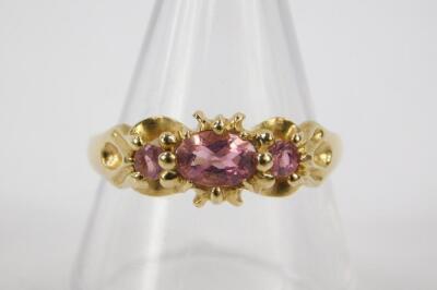 A 9ct gold and pink tourmaline three stone ring