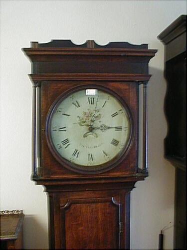 A 19thC cross banded oak and mahogany long case clock with pillared hood