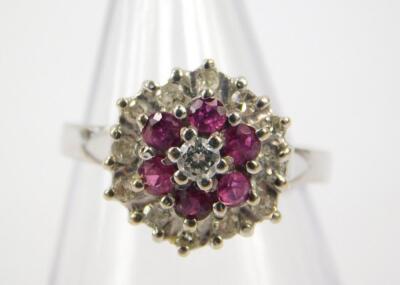 An 18ct white gold ruby and diamond flower head ring