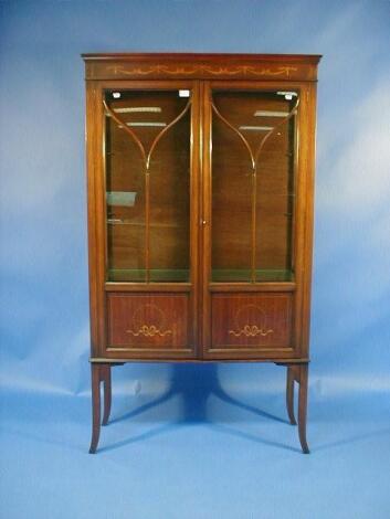 An Edwardian mahogany two door display cabinet with marquetry inlays